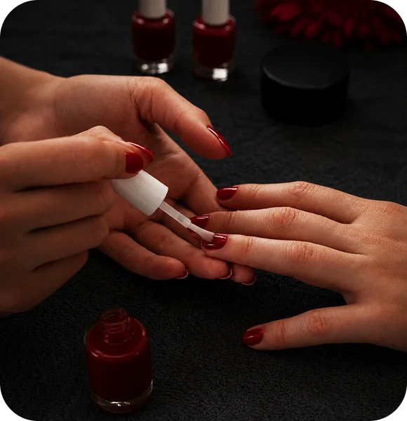 Applying dip powder to fingernails